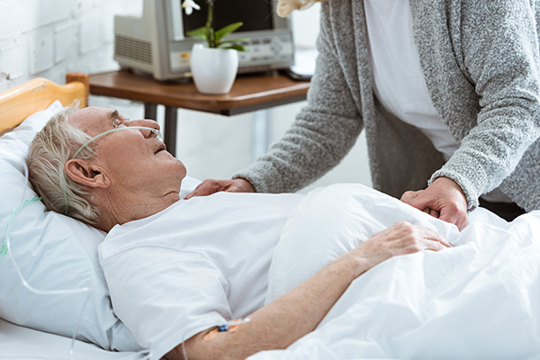 cropped-view-of-senior-woman-with-husband-in-coma-2022-12-22-20-14-25-utc